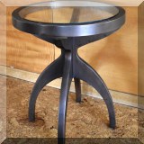 F17. Round metal and glass side table. 24”h x 20”w 